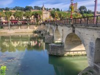 Pont Romain de Sommières - Vue sur le point ormain, le fleuve Vidourle, la tour de l'horloge de la cité médiévale et le château. © Office de Tourisme du Pays de Sommières